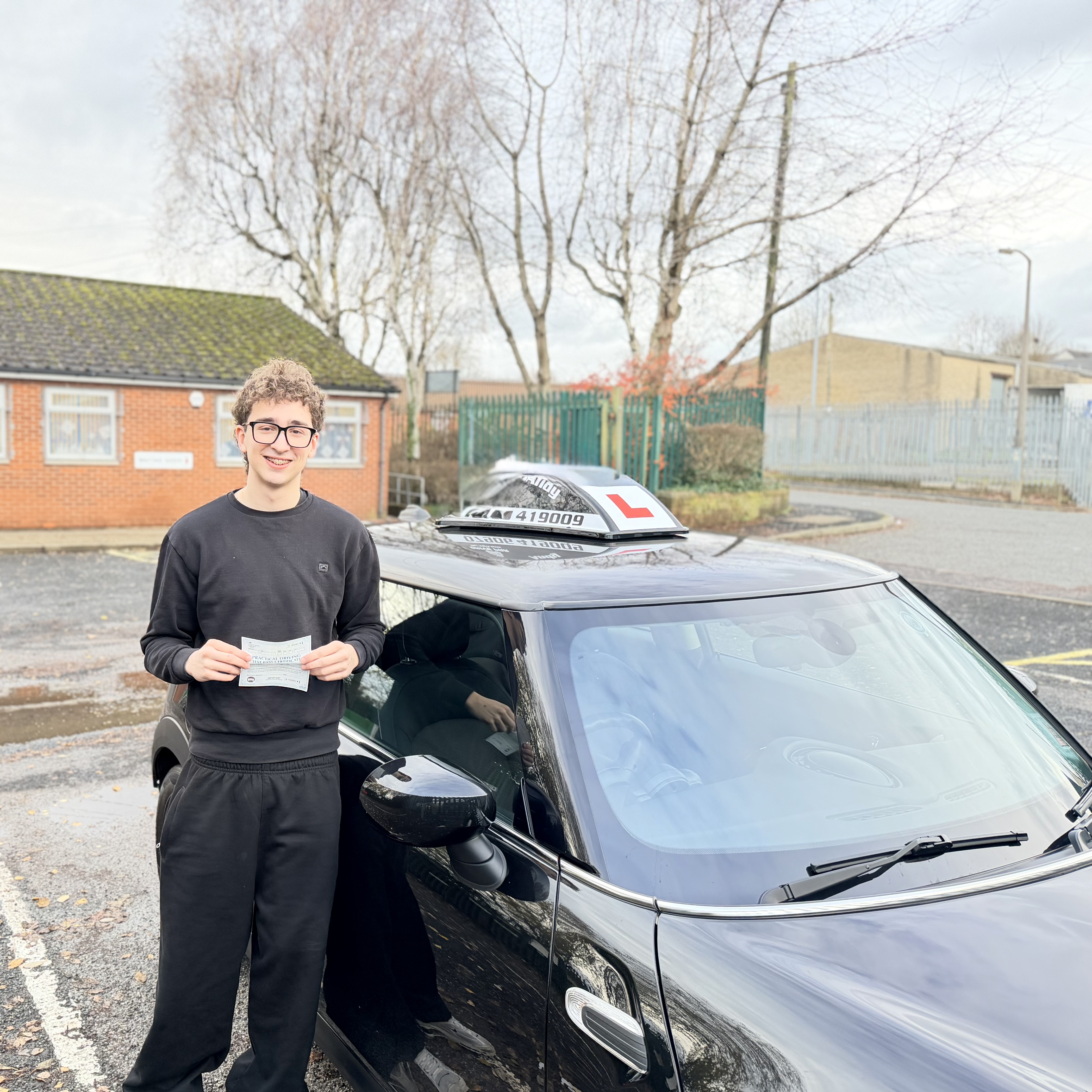 Successful learner beside the Doodles Driving Services Mini